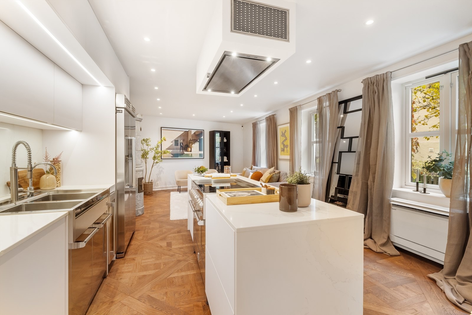 Lys innredning med glatte fronter og benkeplate i stein. Dobbel kum med ettgreps blandebatteri og egen Quooker. Galleribilde