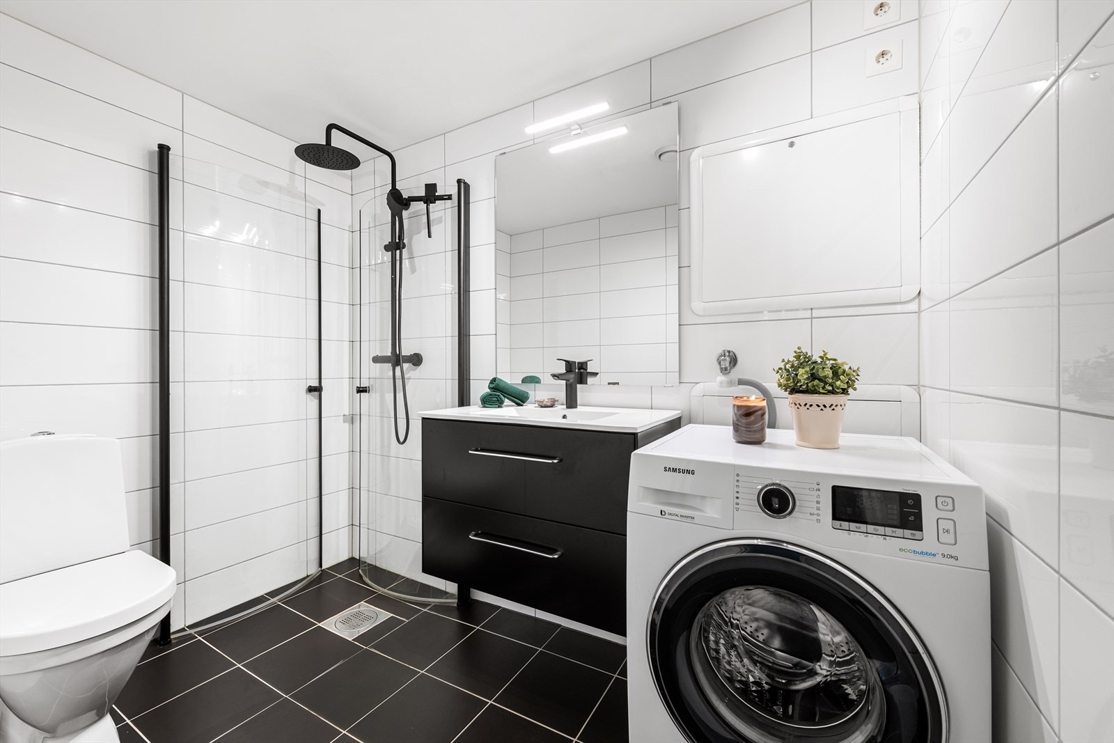 Pent helfliset bad/wc med varmekabler i gulvet. Opplegg for vaskemaskin og tørketrommel. Galleribilde