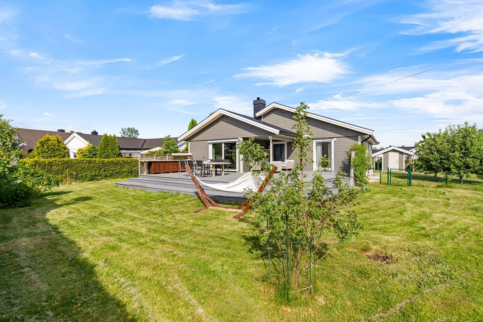 Boligen ligger fint plassert på tomten som gir et romslig plenområde Galleribilde