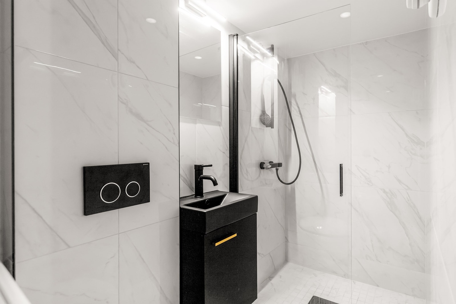 Baderom i hybel av lekker utførelse med dusjnisje og servant i innredning Galleribilde