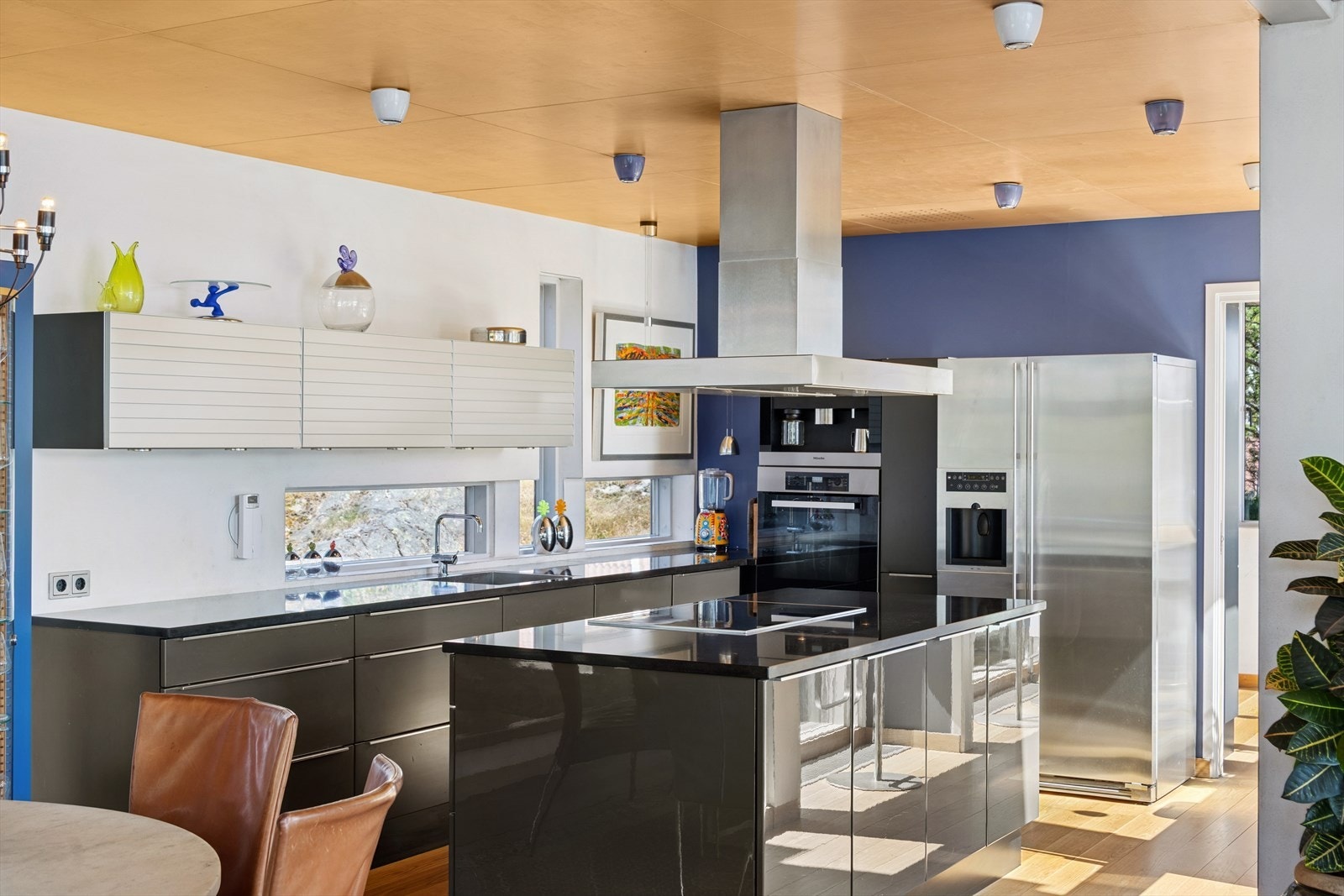 Kjøkkenet har en moderne og tidløs innredning med malte fronter og benkeplate i stein-/komposittmateriale som kombinerer både estetikk og slitestyrke. Galleribilde