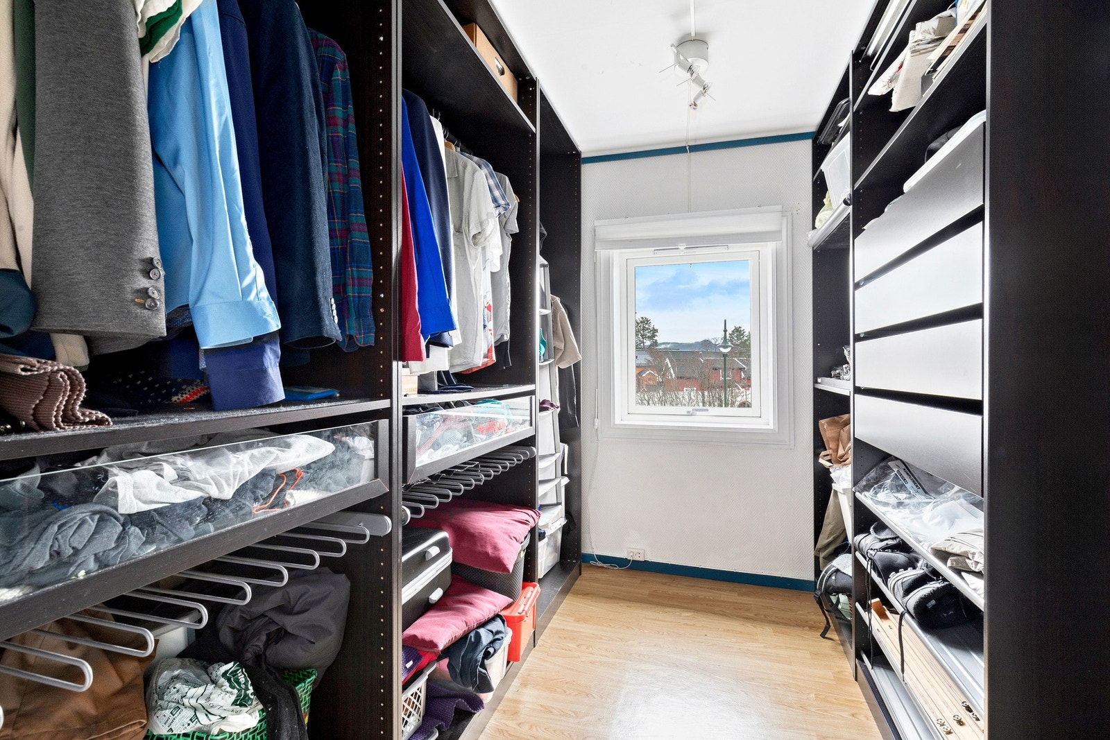 Walk-in closet med god plass til klær og diverse Galleribilde