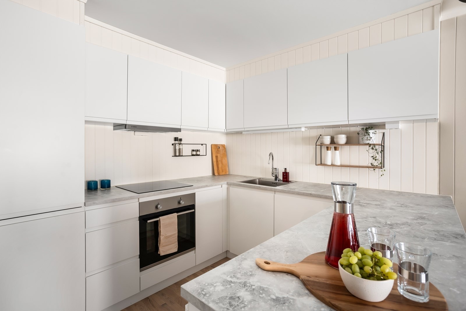 Lyst og pent kjøkken med takhøy innredning og glatte fronter. Galleribilde