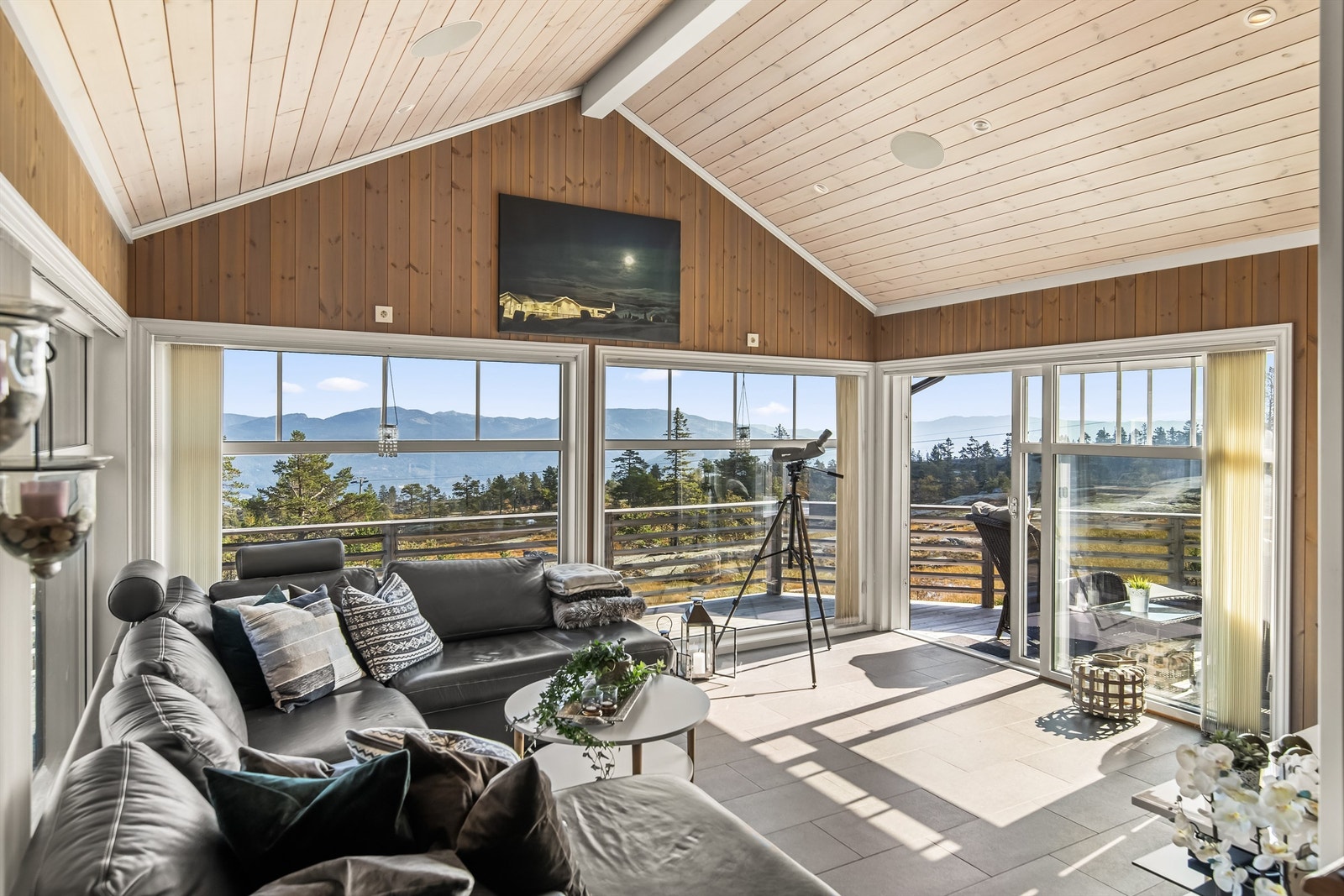 Store vindusflater og åpen himling gir stuen et særpreg og mye naturlig lys Galleribilde