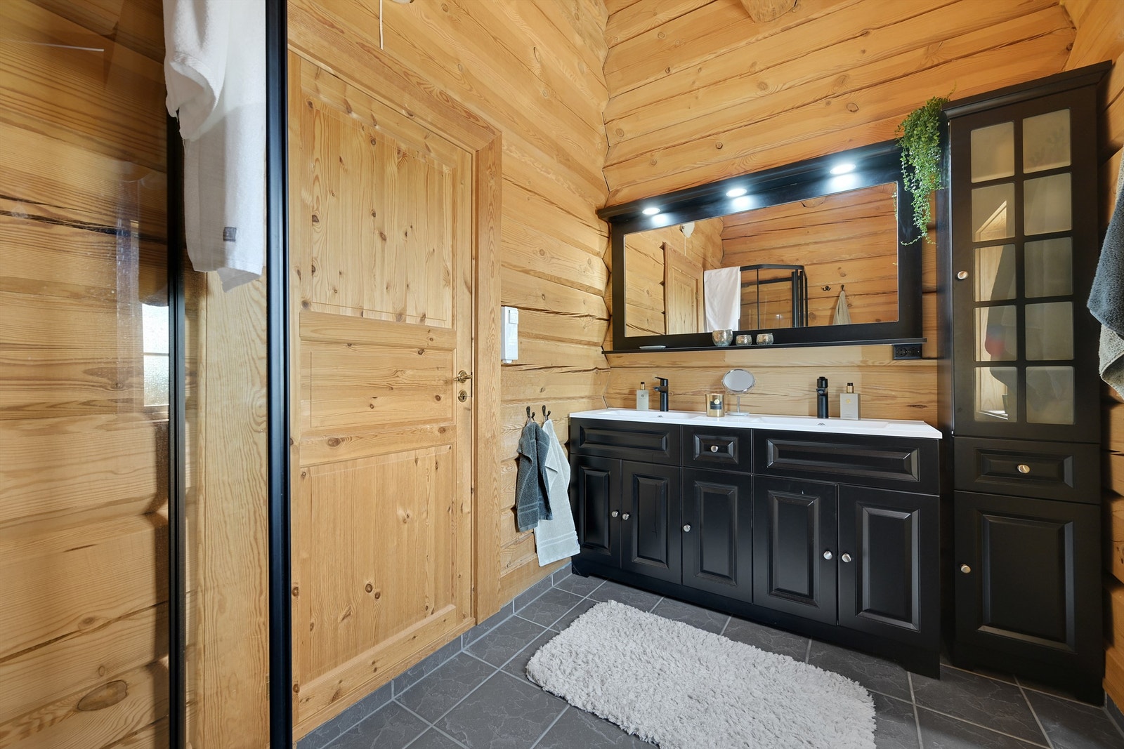 Baderomsinnredningen er fra 2023 og inneholder to nedfelte servanter i baderomsinnredningen, toalett og et dusjkabinett. Galleribilde