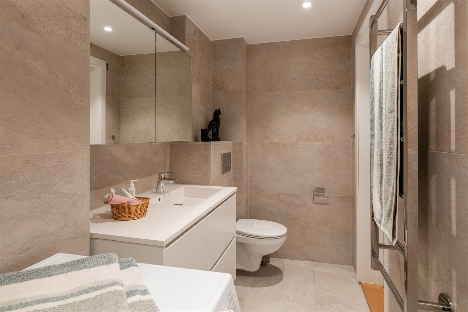 Her er det elektrisk gulvvarme for økt komfort, samt opplegg for vaskemaskin. Galleribilde