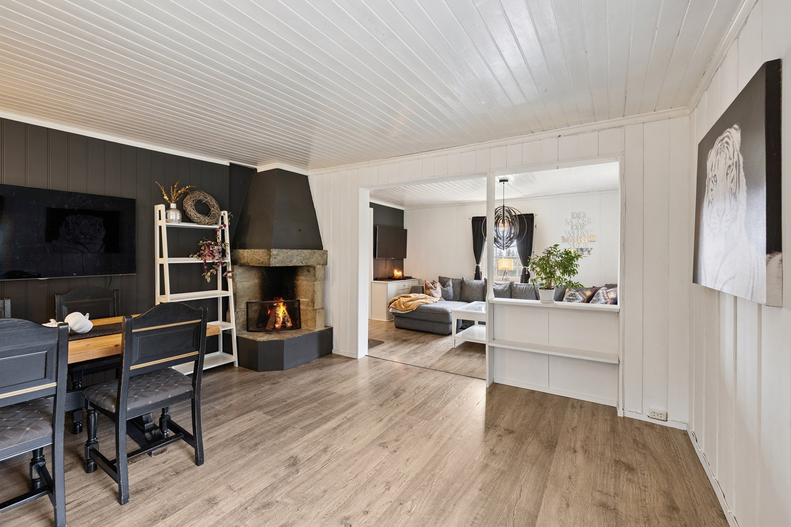 Spisestue og stue med en delvis åpen løsning. Peis midt i arealet. Galleribilde