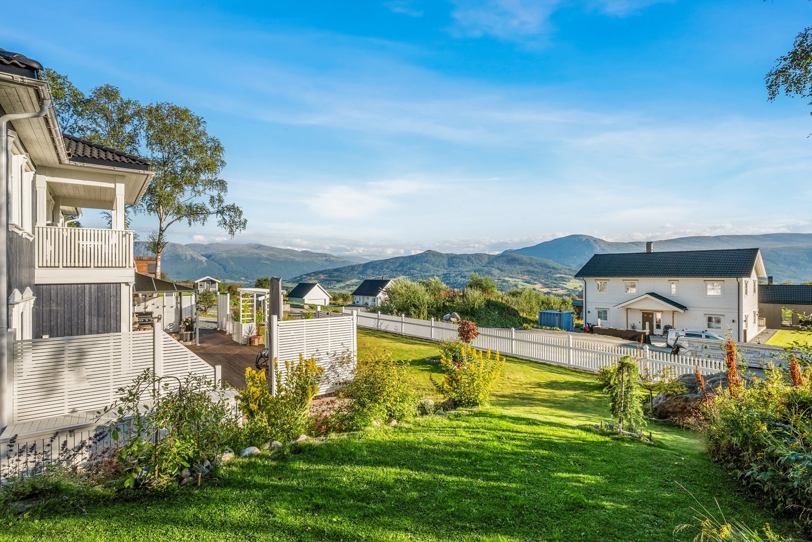 Dagens eier har sørget for pent stell med uteområdet, og plantet blomsterbedd og buskevekster. Galleribilde