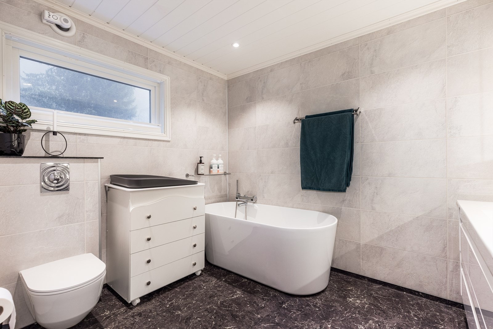 Badet på hovedplan som er rehabilitert i 2018 fremstår lyst og delikat og med moderne interiør. Designbadekar og veggmontert toalett. Galleribilde