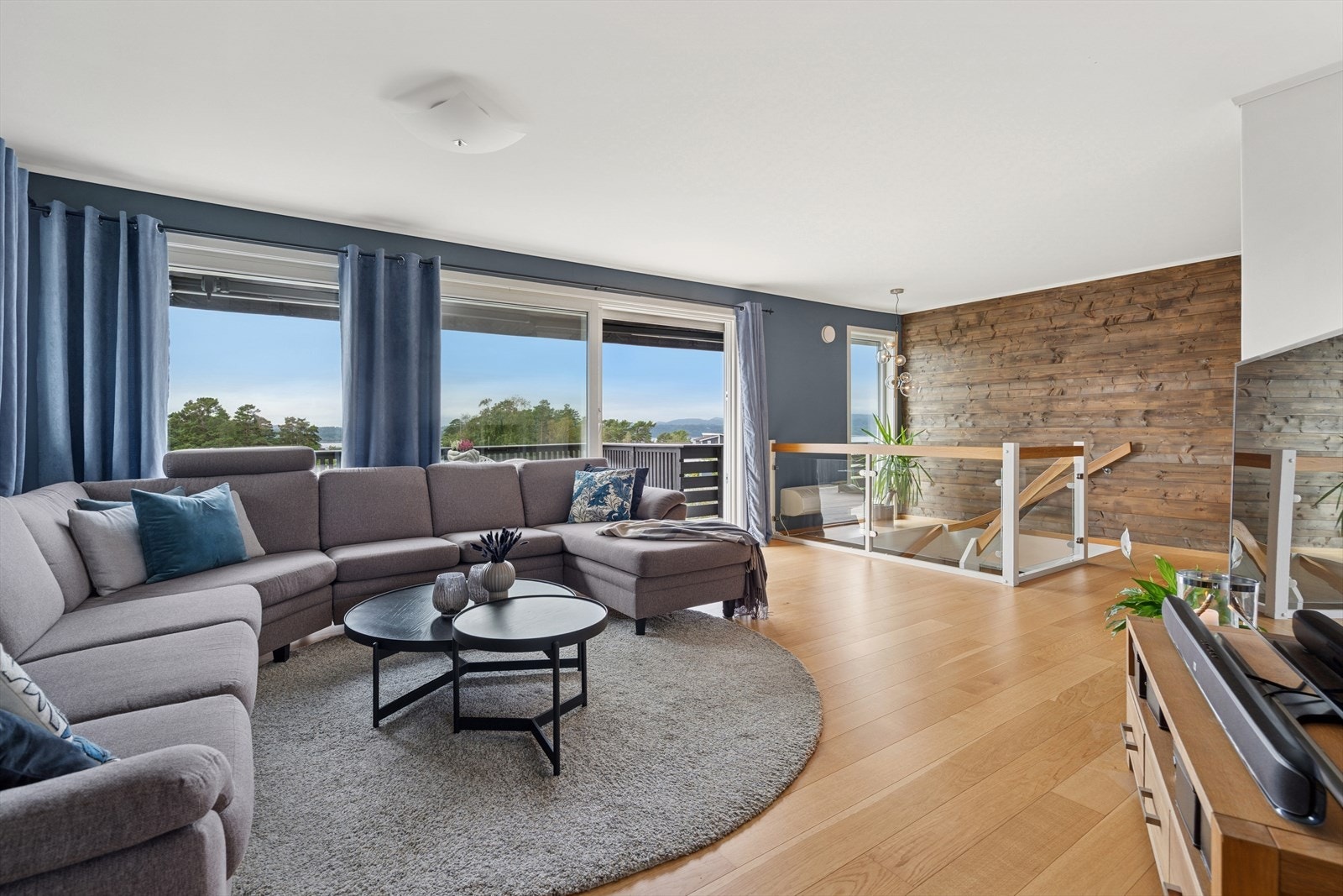 Stuen har store vindusflater som slipper inn rikelig med naturlig lys og skaper en lys og luftig atmosfære. Galleribilde