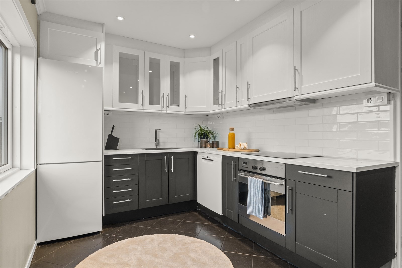 Tidløs kjøkkeninnredning med profilerte fronter og laminat benkeplate Galleribilde