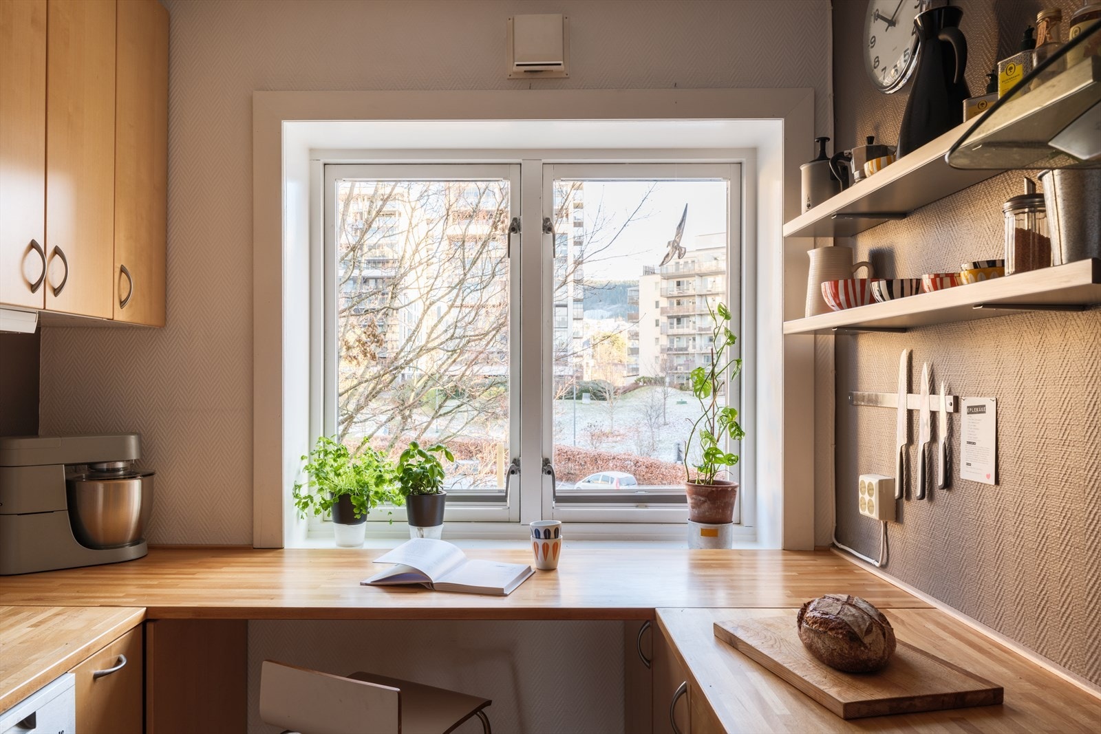 Kjøkkeninnredning med glatte fronter, heltre benkeplate og nedfelt oppvaskkum. Galleribilde