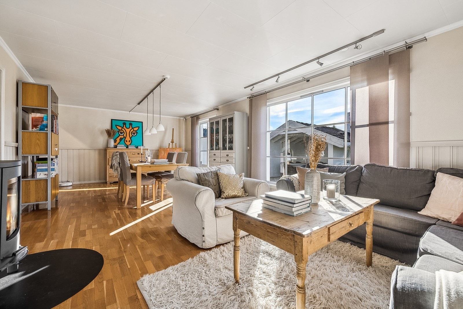 Stuen er åpen og lys med store vinduer. Galleribilde