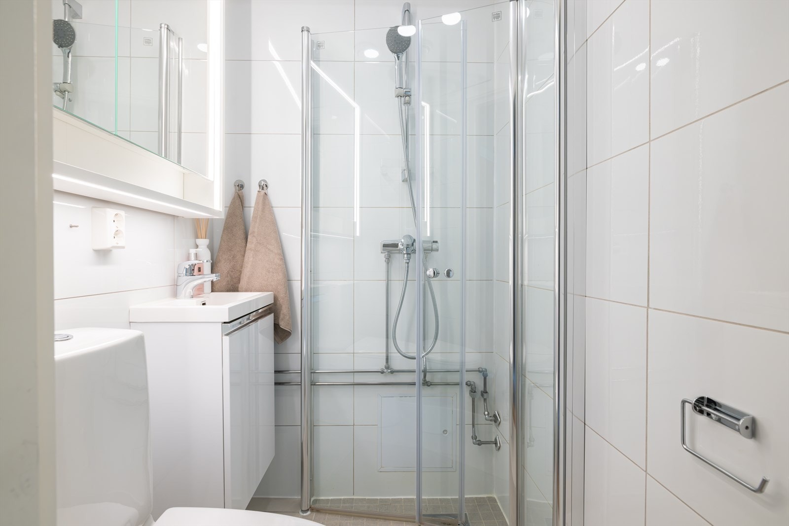 Badet er innredet med servant i skapseksjon og speilskap med lys. Galleribilde