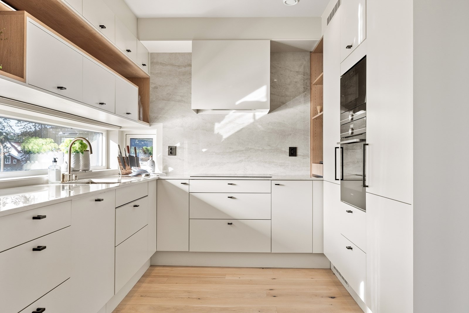 Legg merke til den flotte veggen bak komfyren med heldekkende komposittstein. Galleribilde