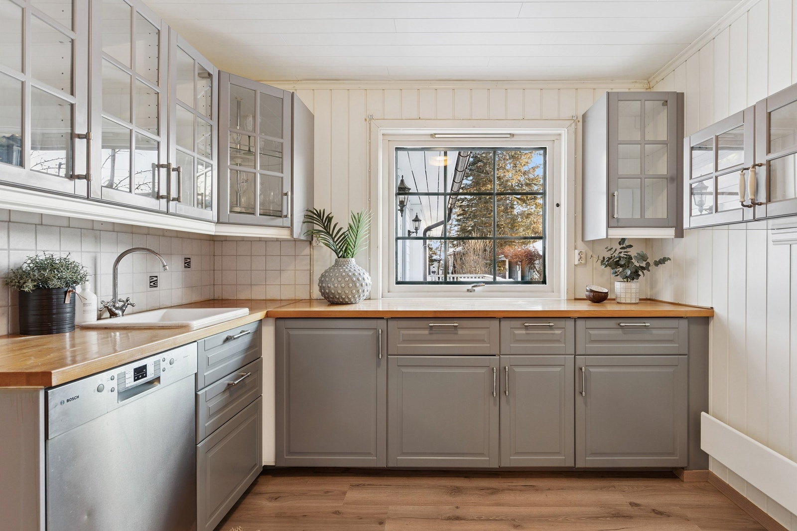 Kjøkken i del 1: Kjøkkeninnredningen har profilerte fronter og inkluderer benkeskap og overskap for praktisk oppbevaring. Benkeplatene er av overflatebehandlet heltre, som er slitesterkt og lette å rengjøre Galleribilde