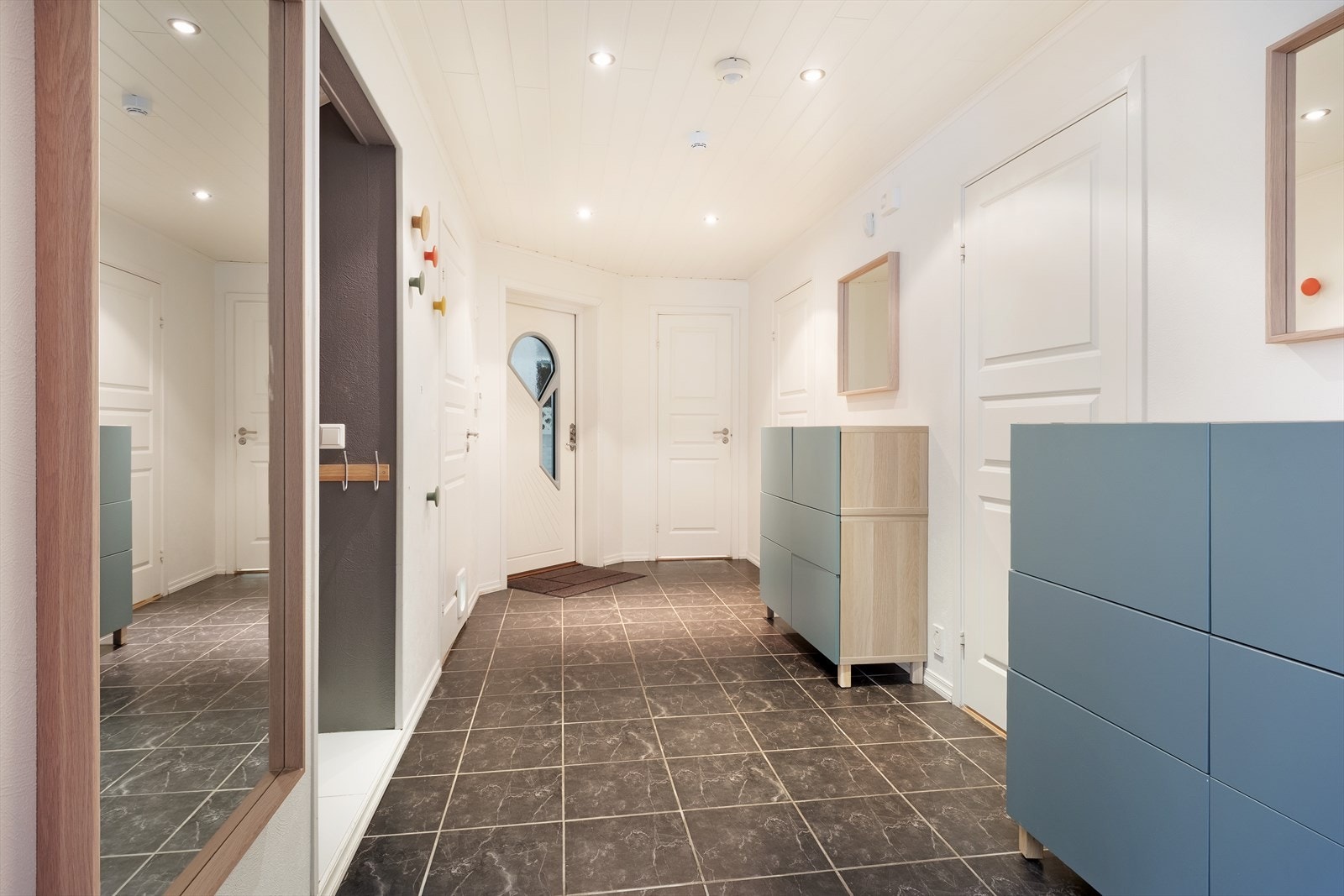 Lys og innbydande gang med flis på golv og spottar i himling. Her har ein god plass til opphengt av ytterklede. Galleribilde