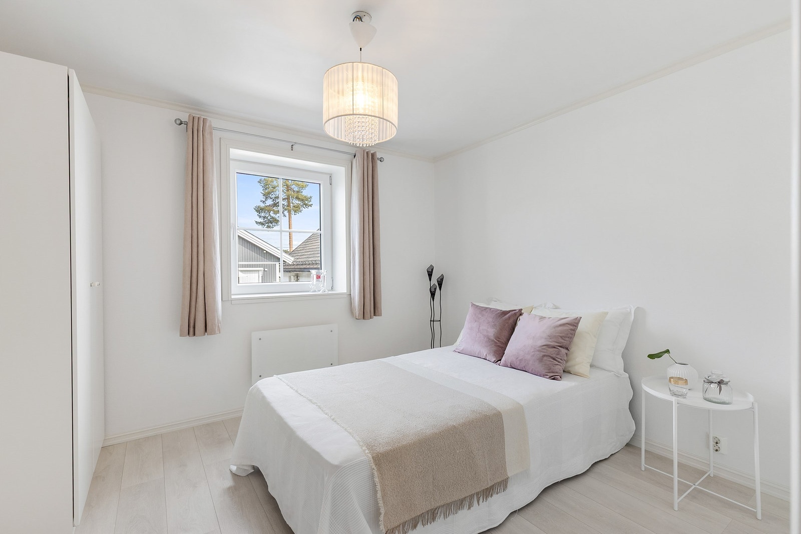 Et av boligens soverom i 1. etasje. Rommet er av god størrelse med plass til dobbeltseng, tilhørende nattbord og kommode. Galleribilde