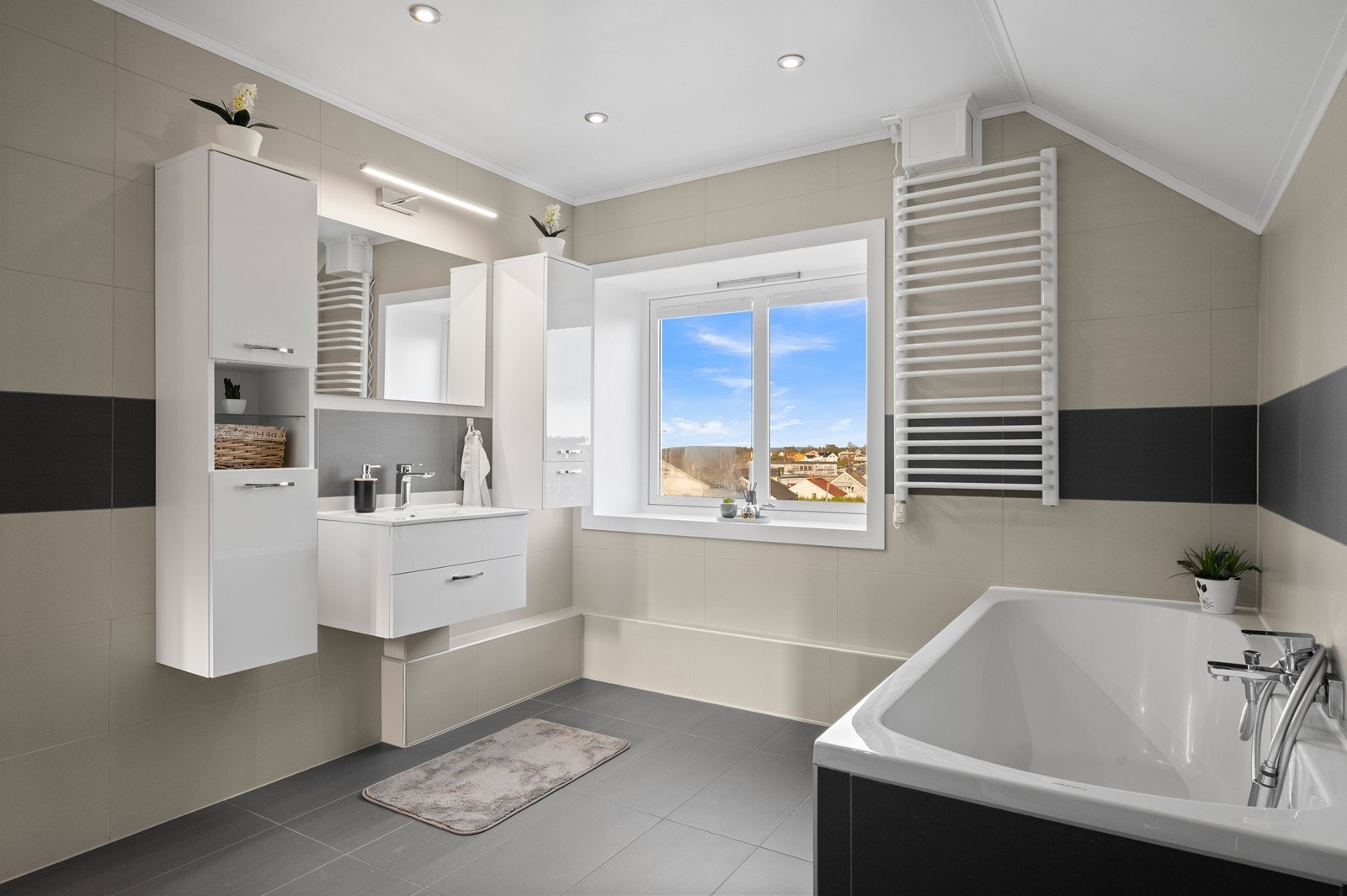 Hovedbadet er helfliset, og ble oppgradert av en tidligere eier i 2015. Rommet er utstyrt med både badekar og håndkletørker. Galleribilde