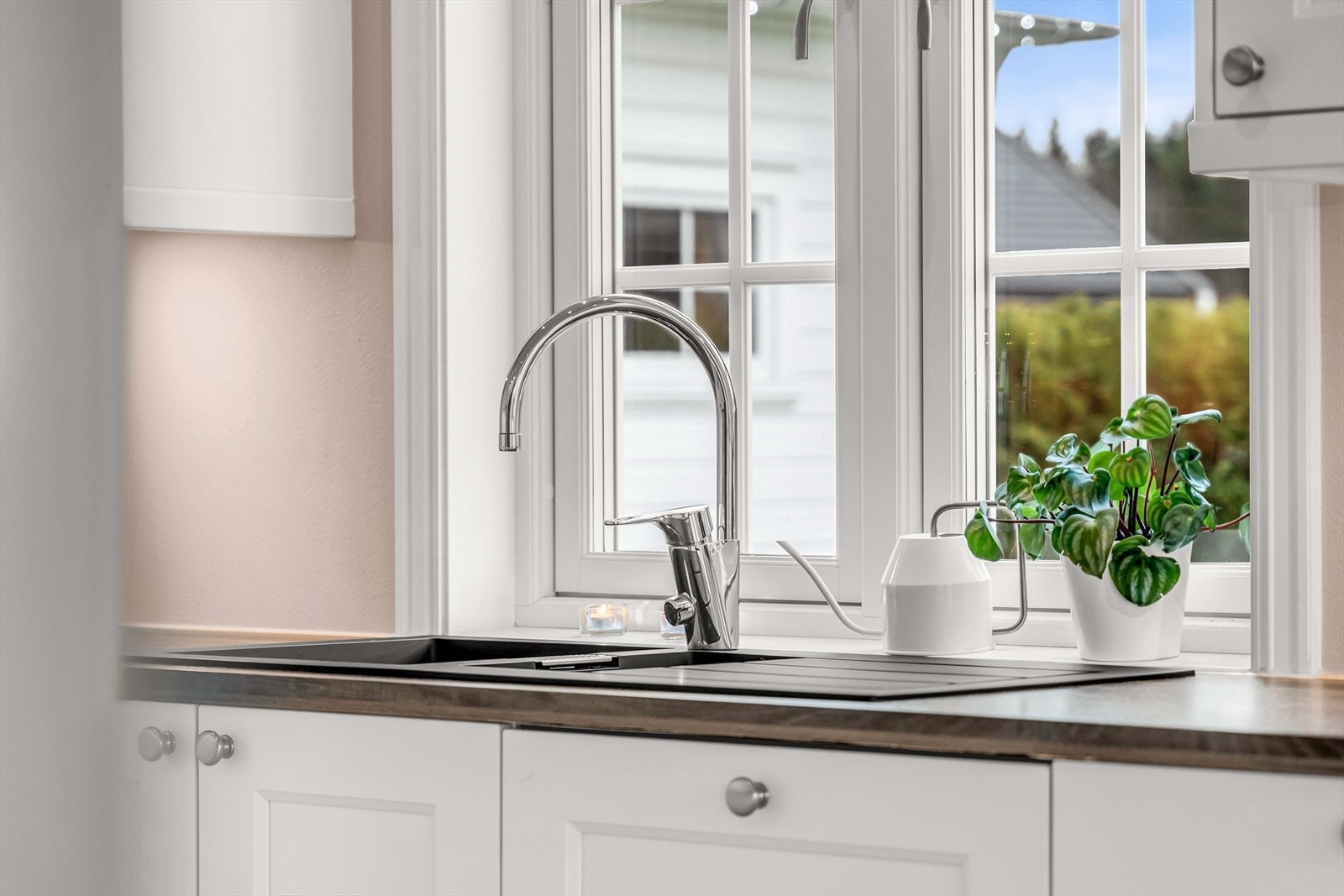 Kjøkkenvindu gir utsikt til hagen og slipper inn dagslys. Galleribilde