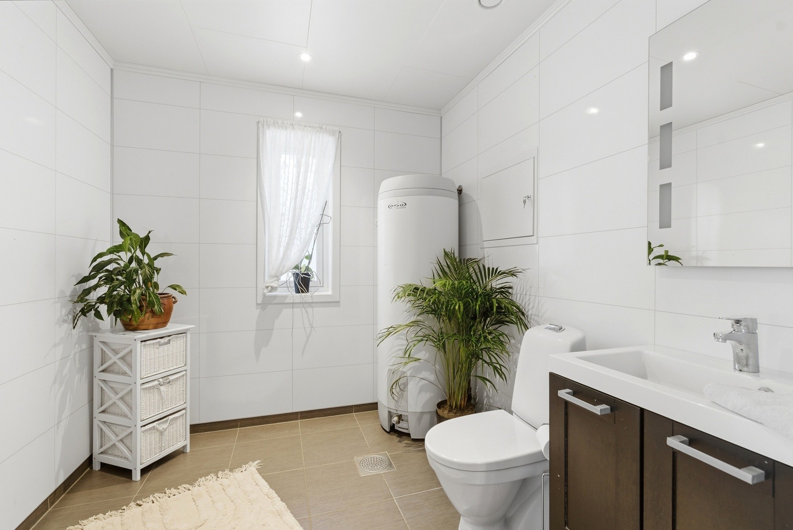 Toalettrom i 1. etg. Tidløst og stilrent preg med baderomsplater på vegg og fliser på gulvet. Galleribilde