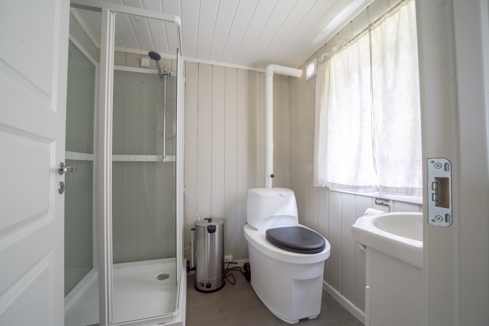 Nybygd baderom med dusjkabinett, toalett og vask. (230W anlegg fra aggregat i uthuset) Galleribilde