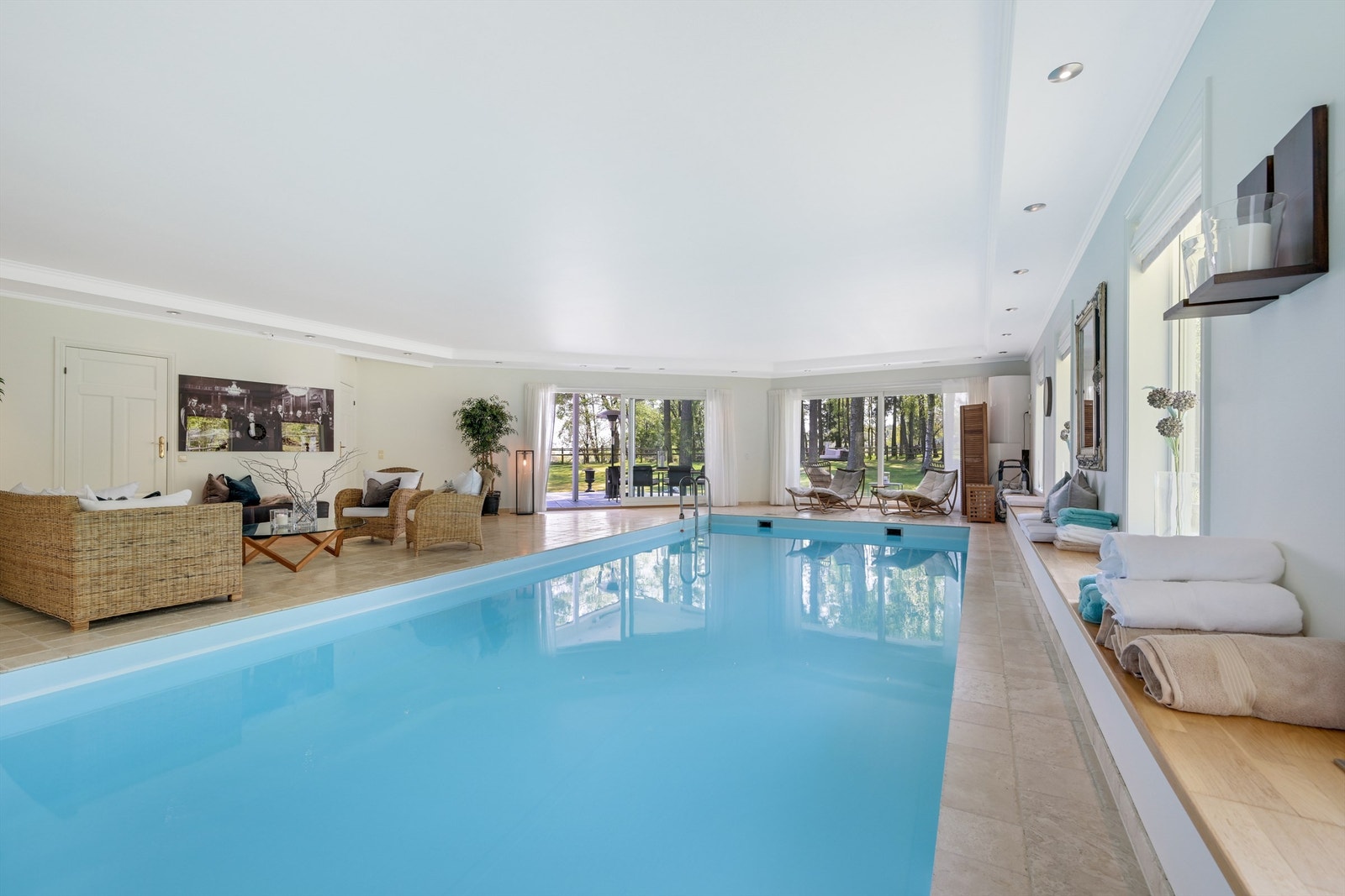 Den store eneboligen har en fløy med garasjeanlegg i den ene enden og et fantastisk spa anlegget med bla. stort svømmebasseng i den andre enden. Galleribilde