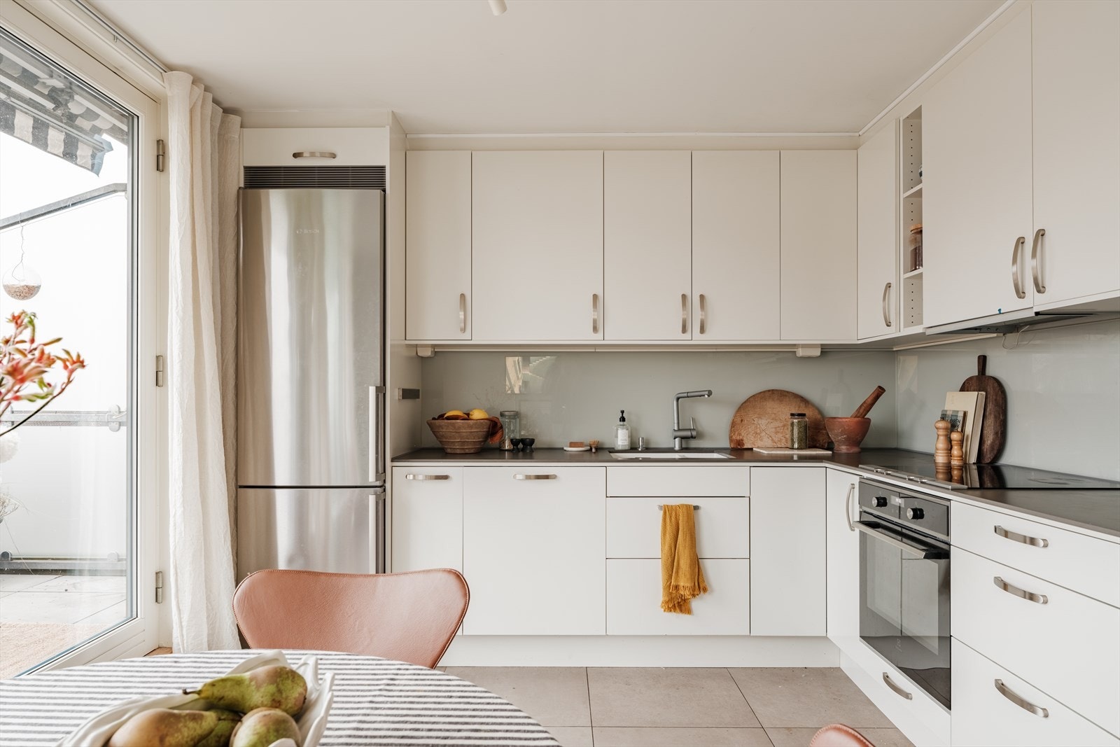 Innredningen er fra Norema og har glatte hvite fronter på skuffer og skap. Godt utstyrt med integrert stekeovn, oppvaskmaskin og induksjonstopp, samt ventilator med avtrekk ut. Galleribilde