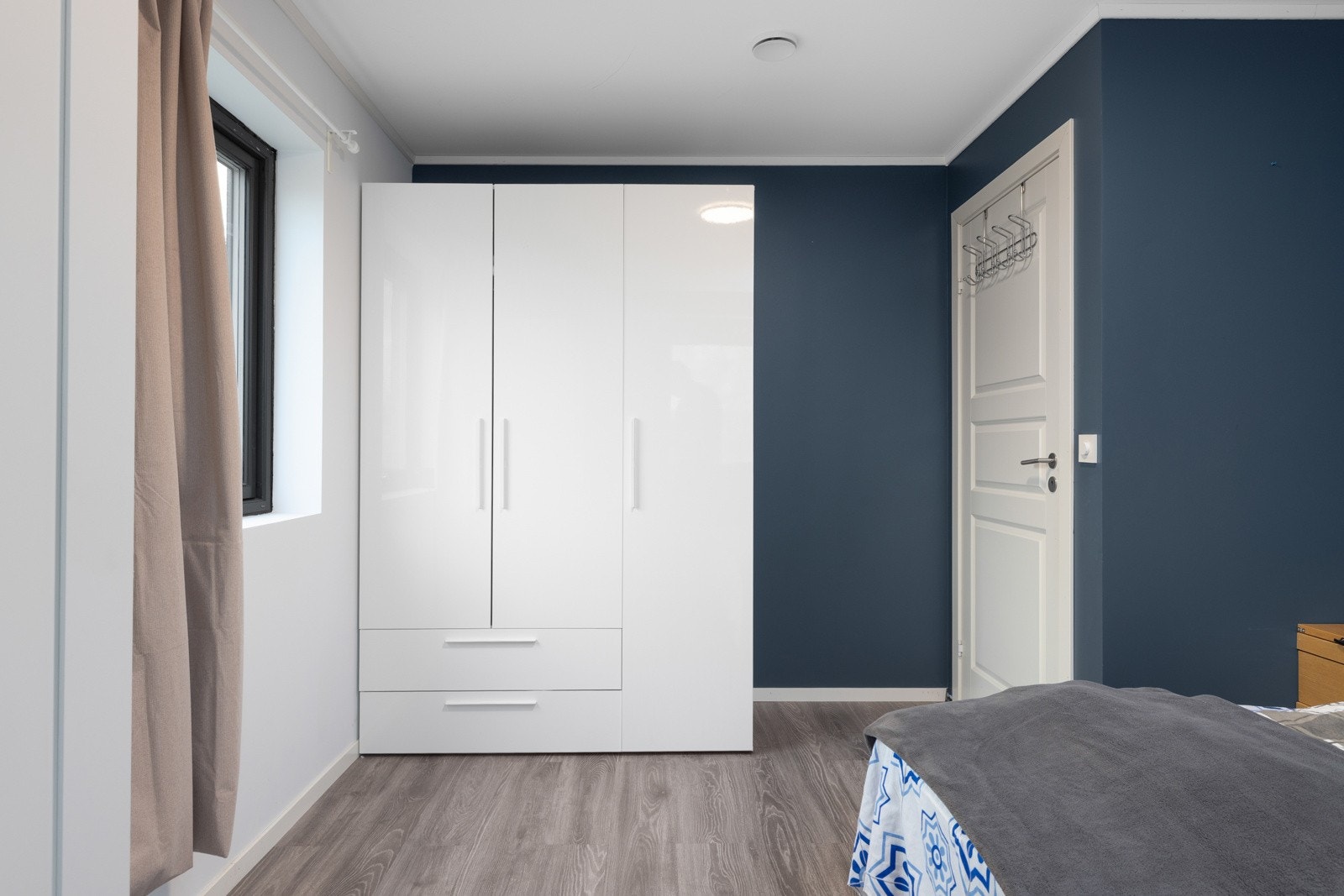 Soverom med smart oppbevaring og stilrene farger. Galleribilde