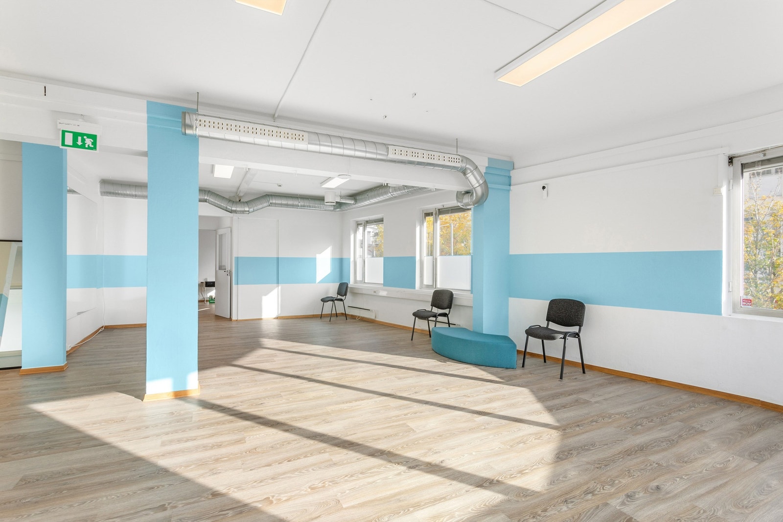 Lyst og åpent landskap med mye vinduer i bygningens fasader. Galleribilde