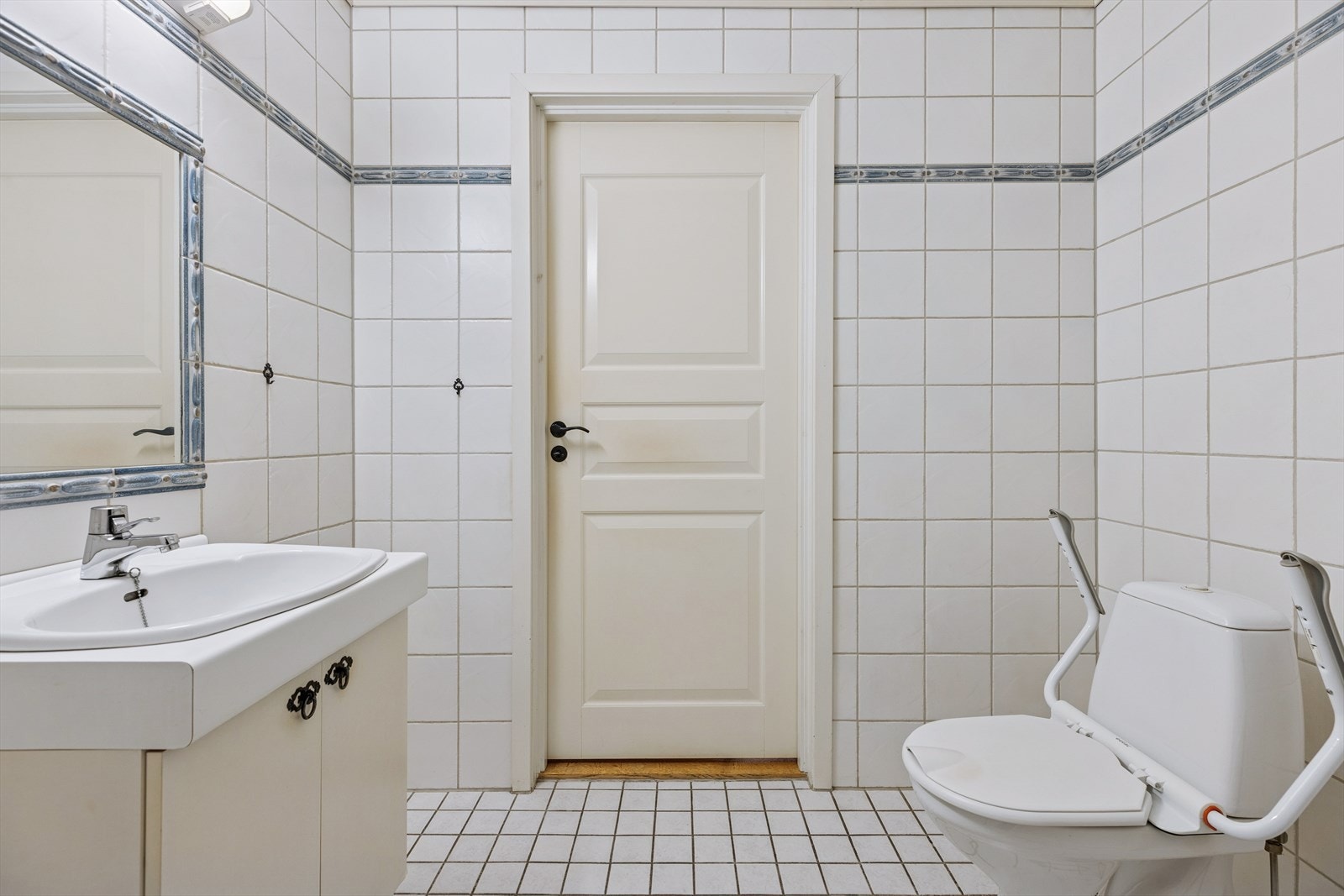 Badet er utstyrt med servantinnredning, speil, dusjkabinett, og gulvmontert toalett. Galleribilde