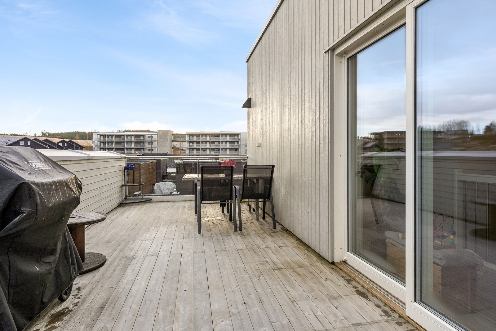 Terrassen har en kombinasjon av tett rekkverk for skjerming og rekkverk i glass som gir fri sikt mot nærområdet Galleribilde