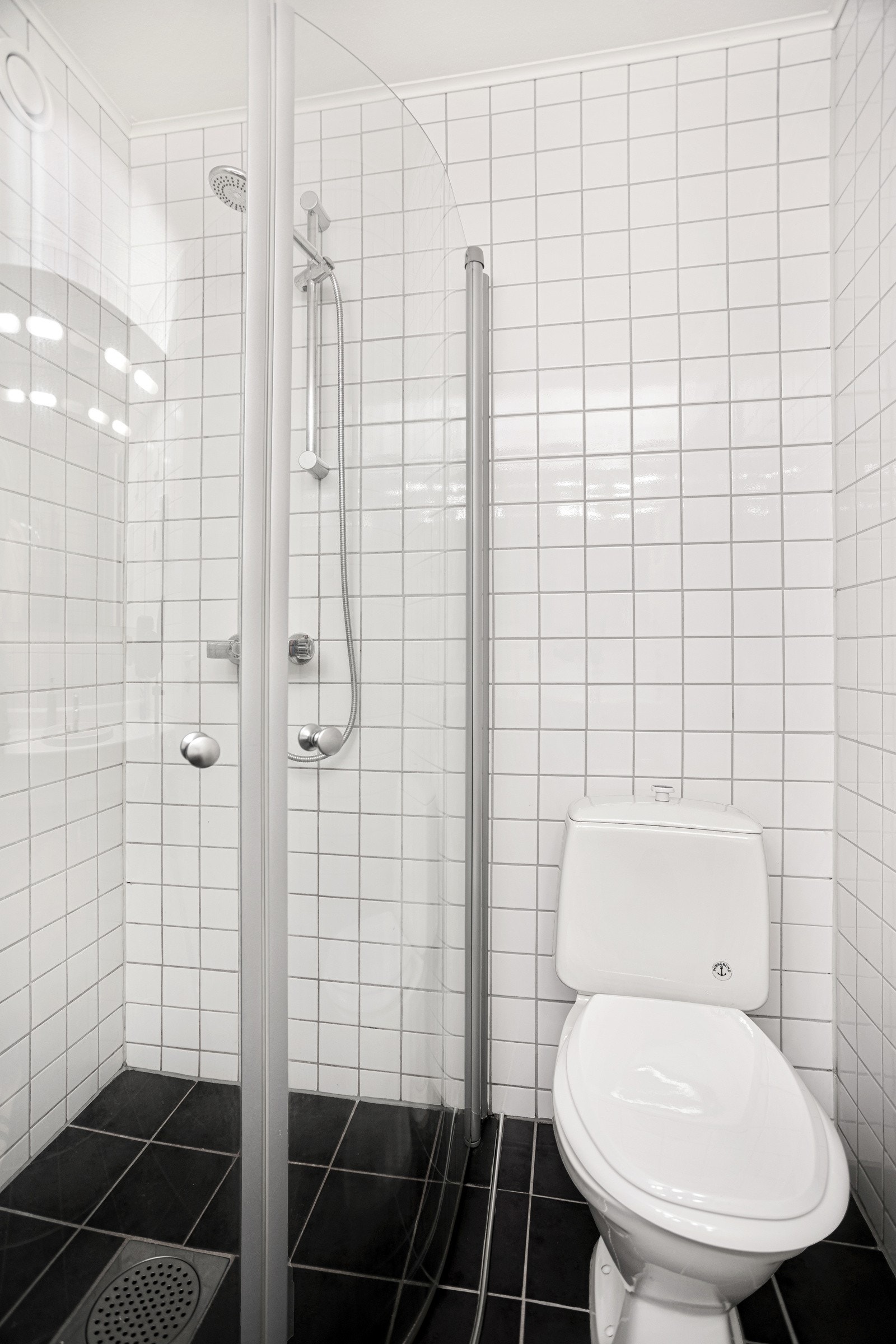 Bad I inneholder dusjhjørne med glassvegger, servant i innredning og toalett Galleribilde