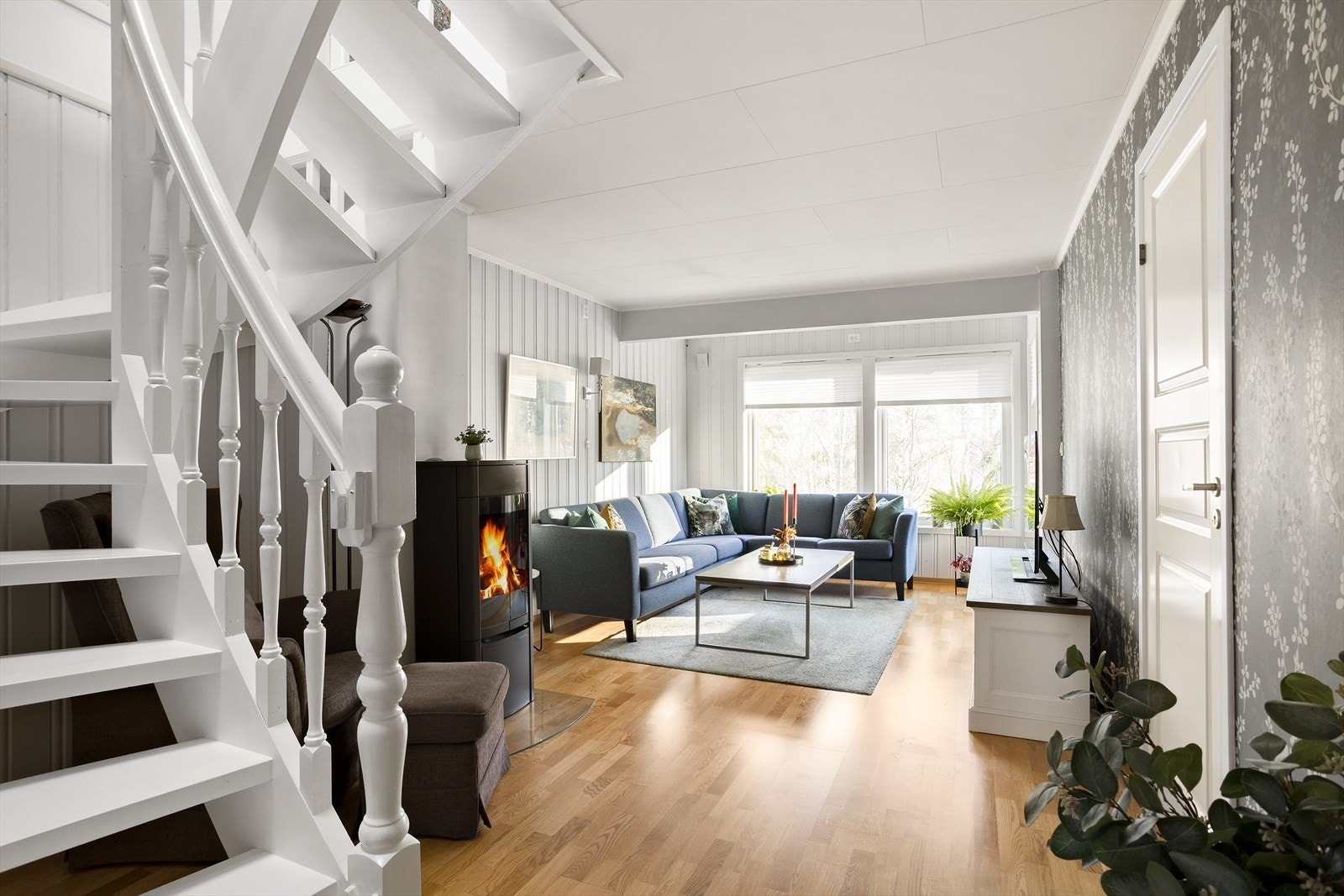 Stuen ligger i tilknytning til kjøkkenet og har store vinduer og en glassdør vendt ut mot den overbygde balkongen. Galleribilde