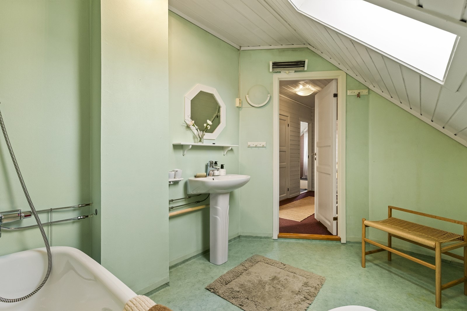 Badet er innredet med badekar med dusj på vegg, sokkeltoalett, samt sokkelservant. For øvrig er det elektrisk styrt avtrekk og takvindu. Galleribilde