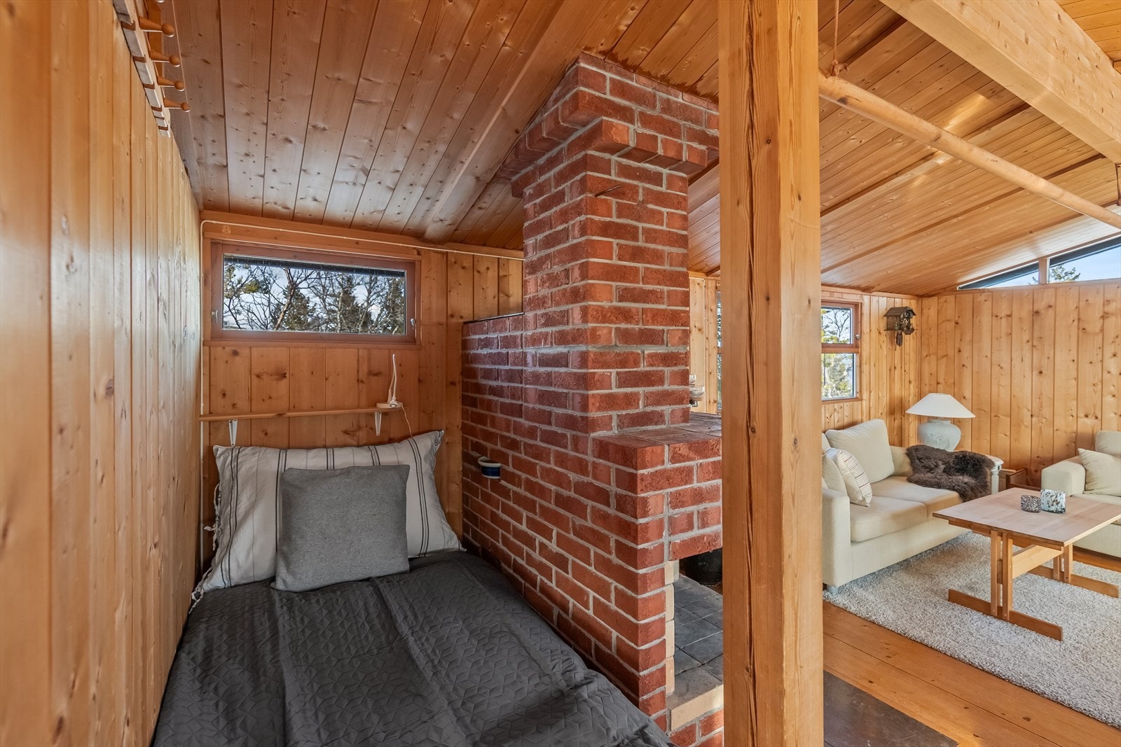 Føreste seng er praktisk plassert bak peisen. Så her vil man alltid holde seg god og varm Galleribilde