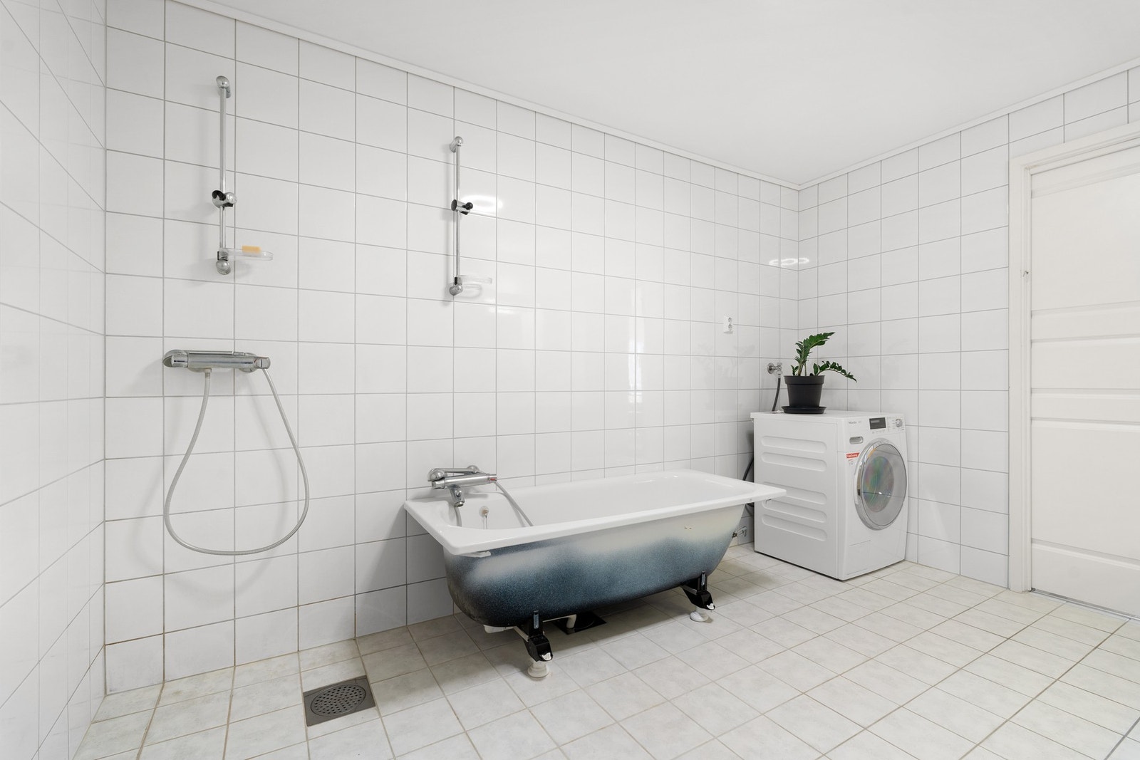 Badet er utstyrt med bl.a. dusjhjørne, badekar, servant, klosett og opplegg til vaskemaskin. Galleribilde