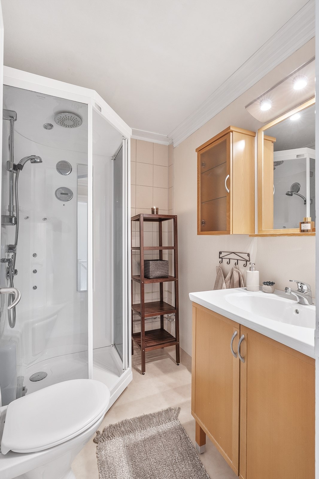 Bad i 2.etg med belegg på gulv og fliser/tapet på vegg. Malte himlingsflater. Innredet med dusjkabinett, toalett, gulvstående servant, speil med overlys Galleribilde