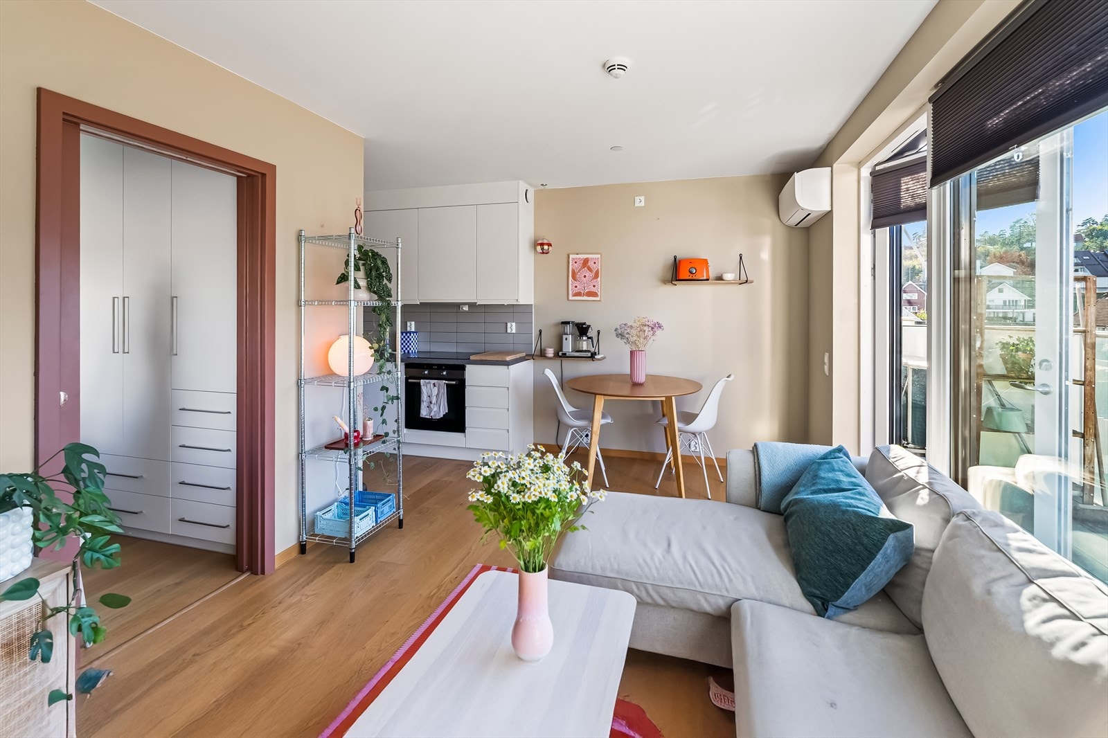 En helglasset terrassedør og store vindusflater gir god kontakt med uteområdene og slipper inn rikelig med naturlig lys. Galleribilde