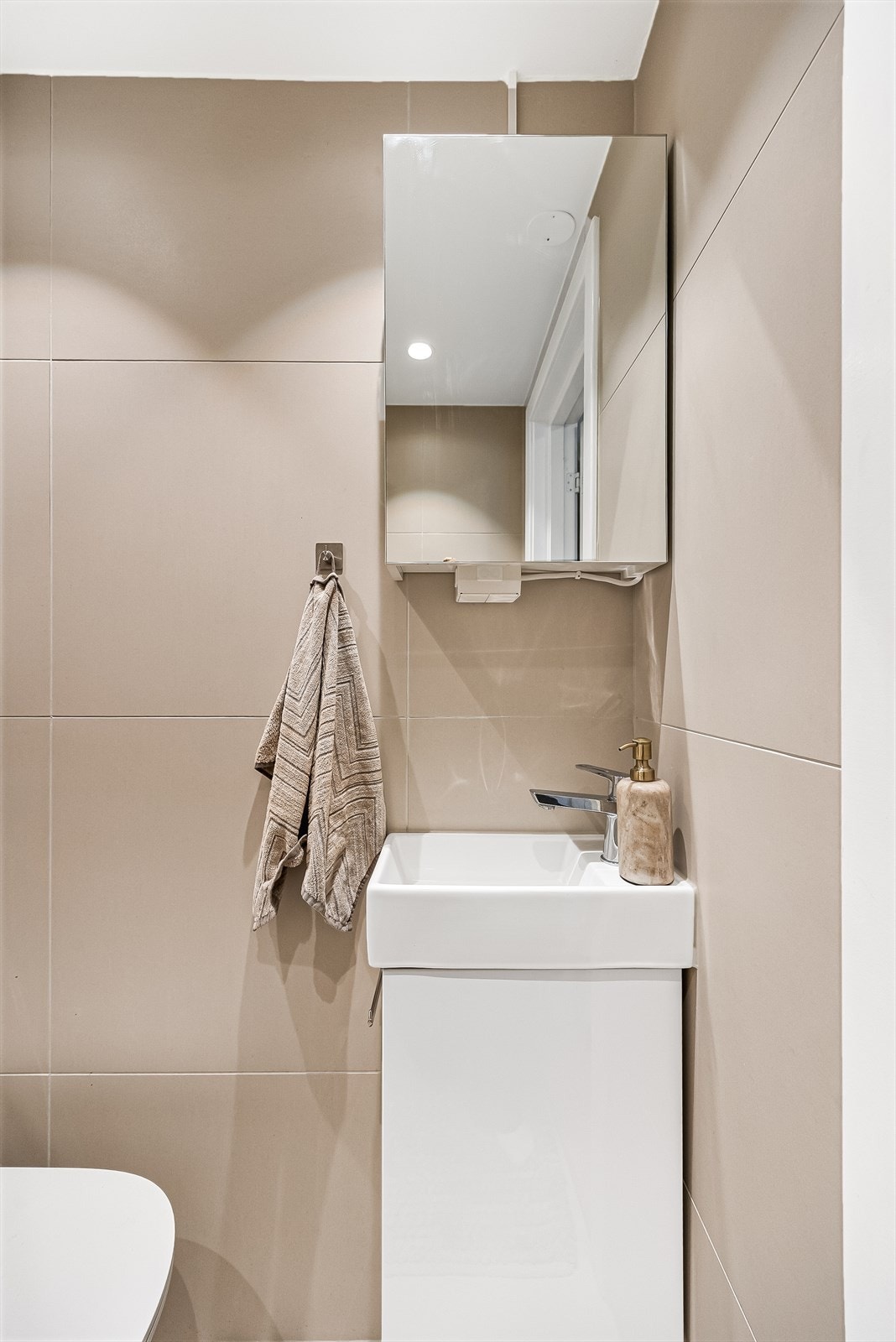 Servant med ovenpåliggende vask og speilskap med stikkontakt over servant. Galleribilde