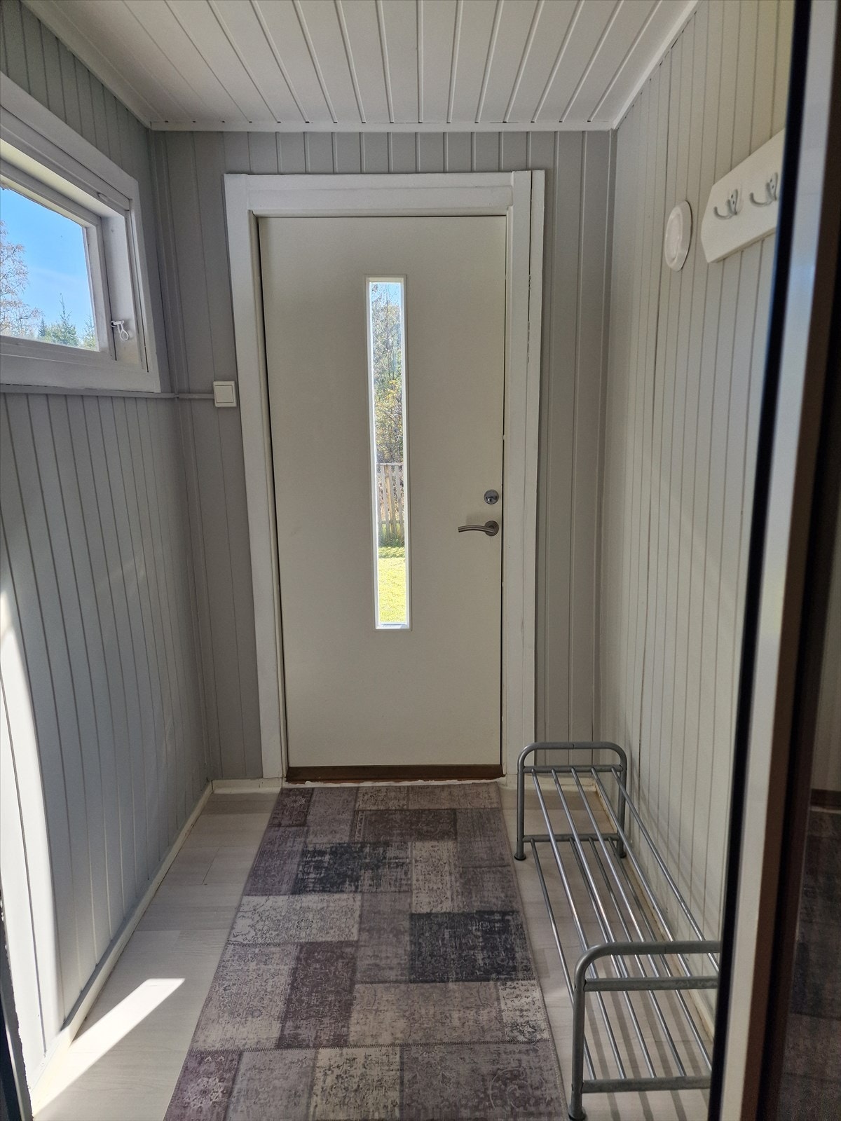 Lys gang med plass til å henge fra seg yttertøy. Galleribilde