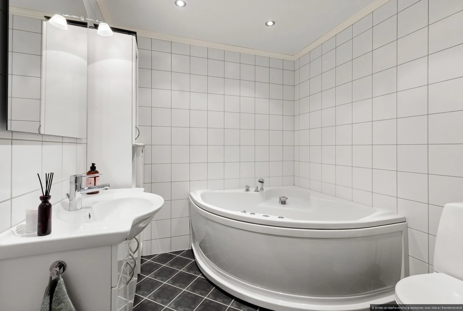 Flislagt bad i første etasje med badekar og gulvvarme Galleribilde