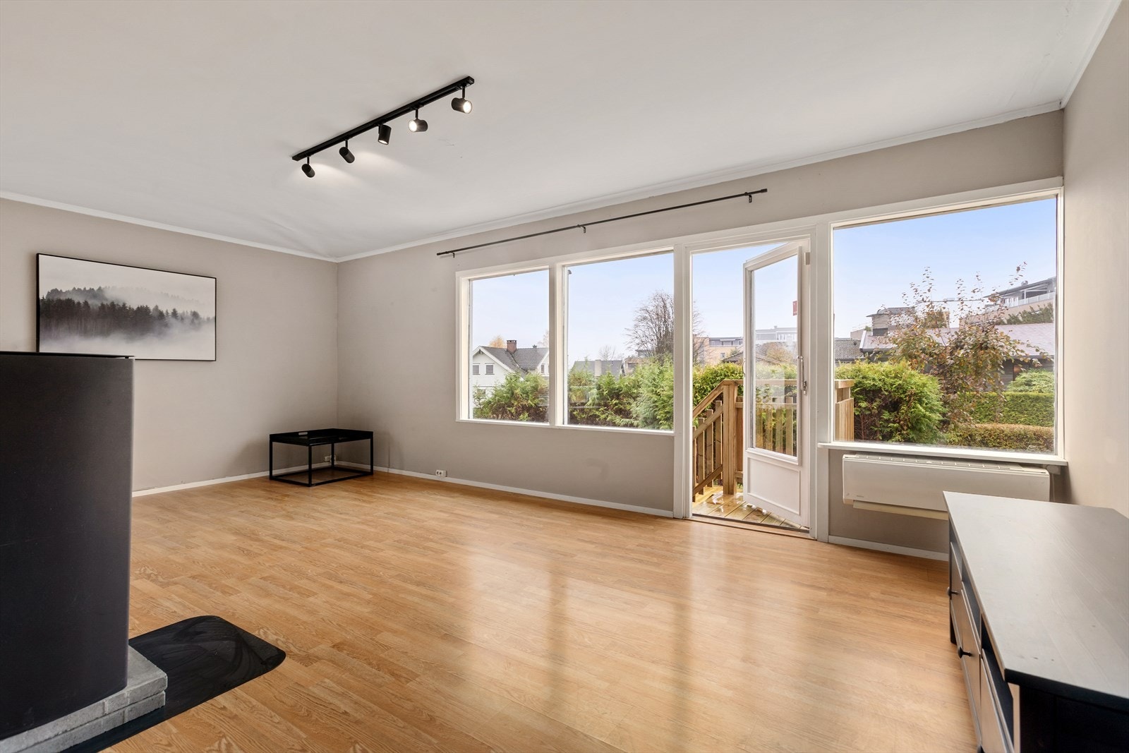 Stuen har store vinduer som gir godt med naturlig lys, samt utgang til terrassen Galleribilde