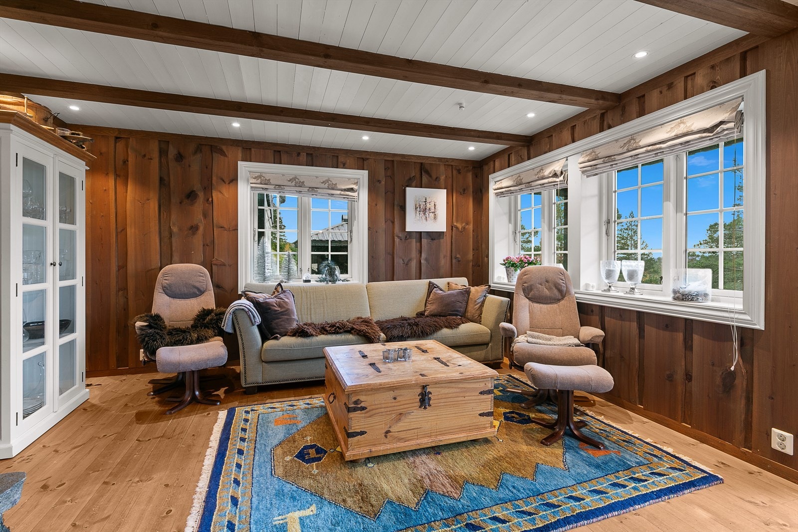 Den opprinnelige stuen har peis, vedovn og åpen løsning mot kjøkken. Galleribilde