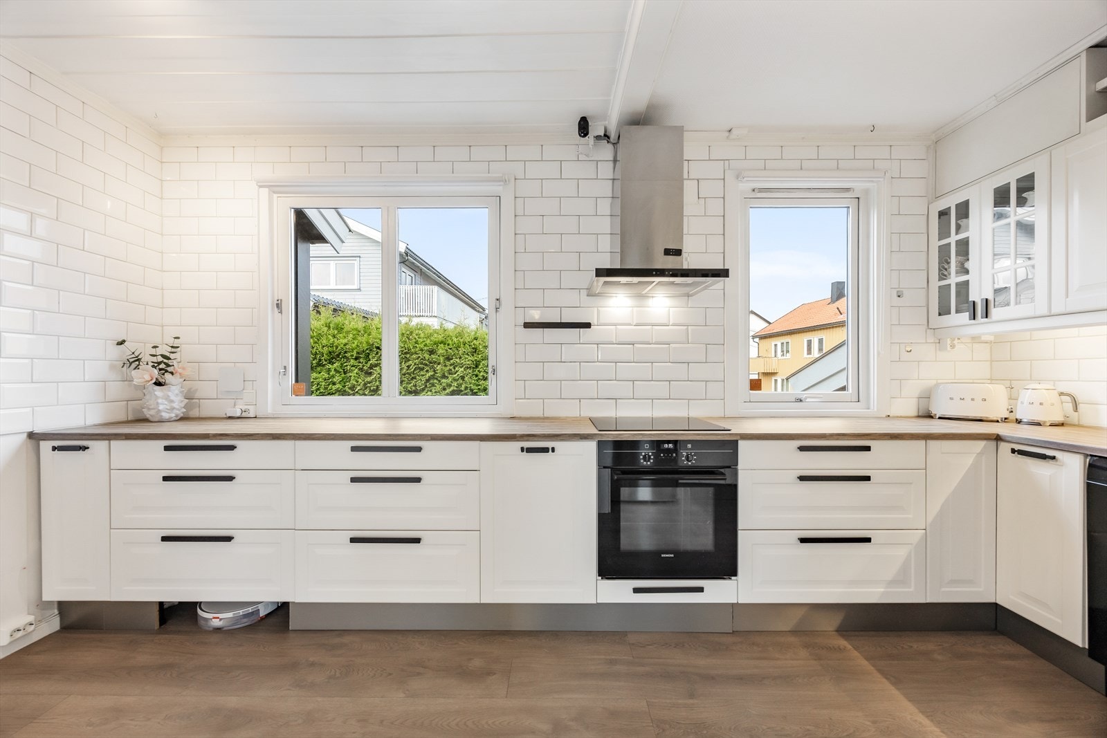 Hvite subway-fliser pryder og beskytter bakveggene og ventilatoren har avtrekk ut Galleribilde