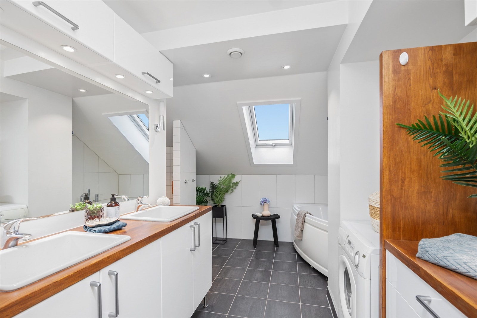 Videre er det et herlig badekar med badekarmatur og hånddusj, og dusjnisje med dusjdør av glass. Galleribilde