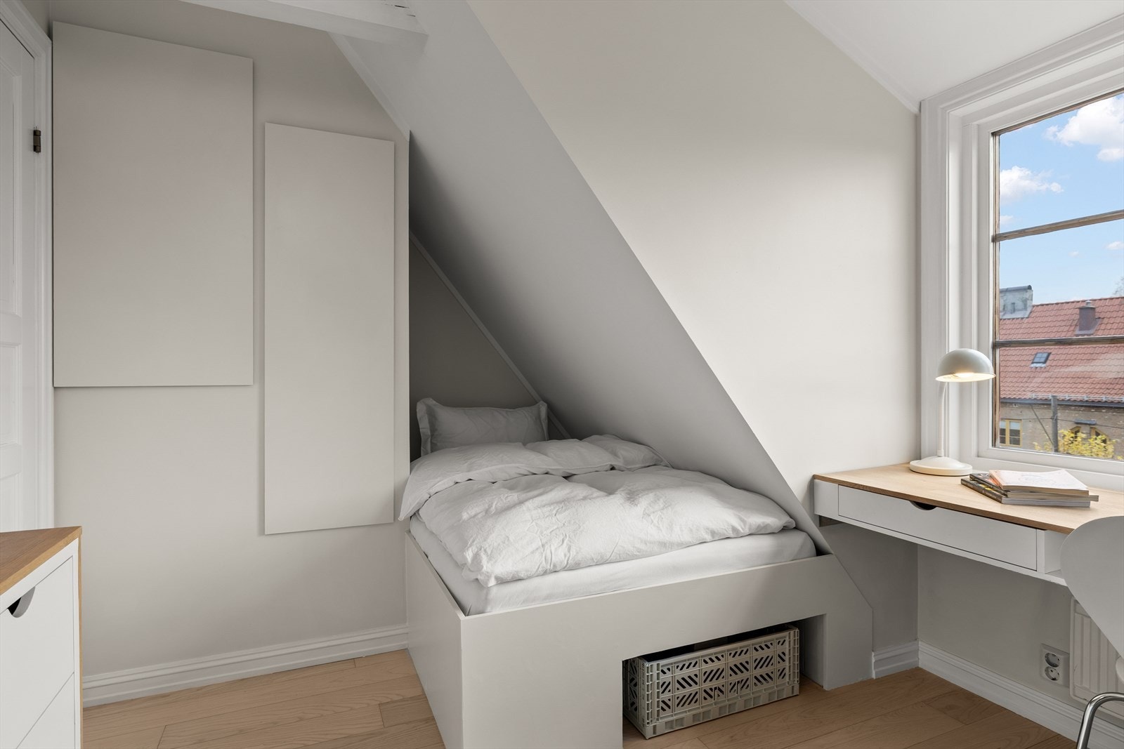 Den plassbygde sengen er både svært lekkert utført og gjennomført integrert i rommet, og gir en smart og stilren løsning som utnytter skråtaket på best mulig måte. Galleribilde