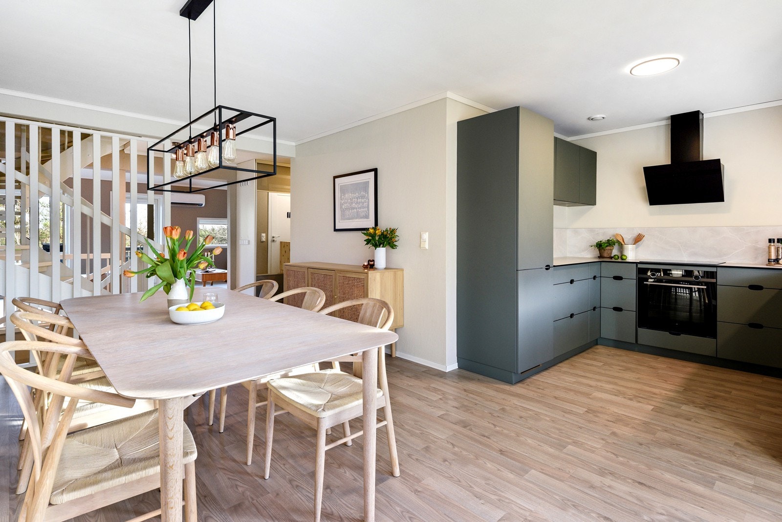 Det stilrene KVIK-kjøkkenet fra 2022 er et naturlig blikkfang, med fronter i en dus grønntone og en praktisk U-form som gir godt med benkeplass og oppbevaring. Galleribilde