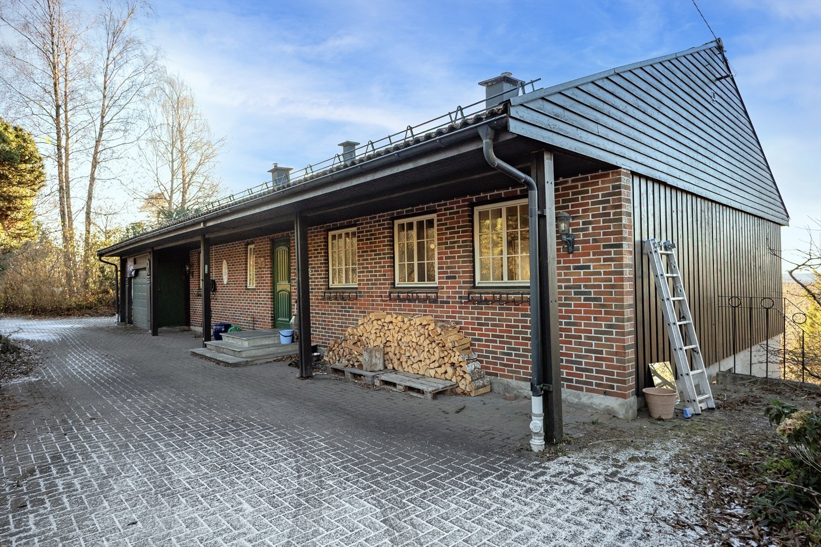 Inngangspartiet er overbygd, og det er gode parkeringsmuligheter på den steinlagte gårdsplassen. Galleribilde