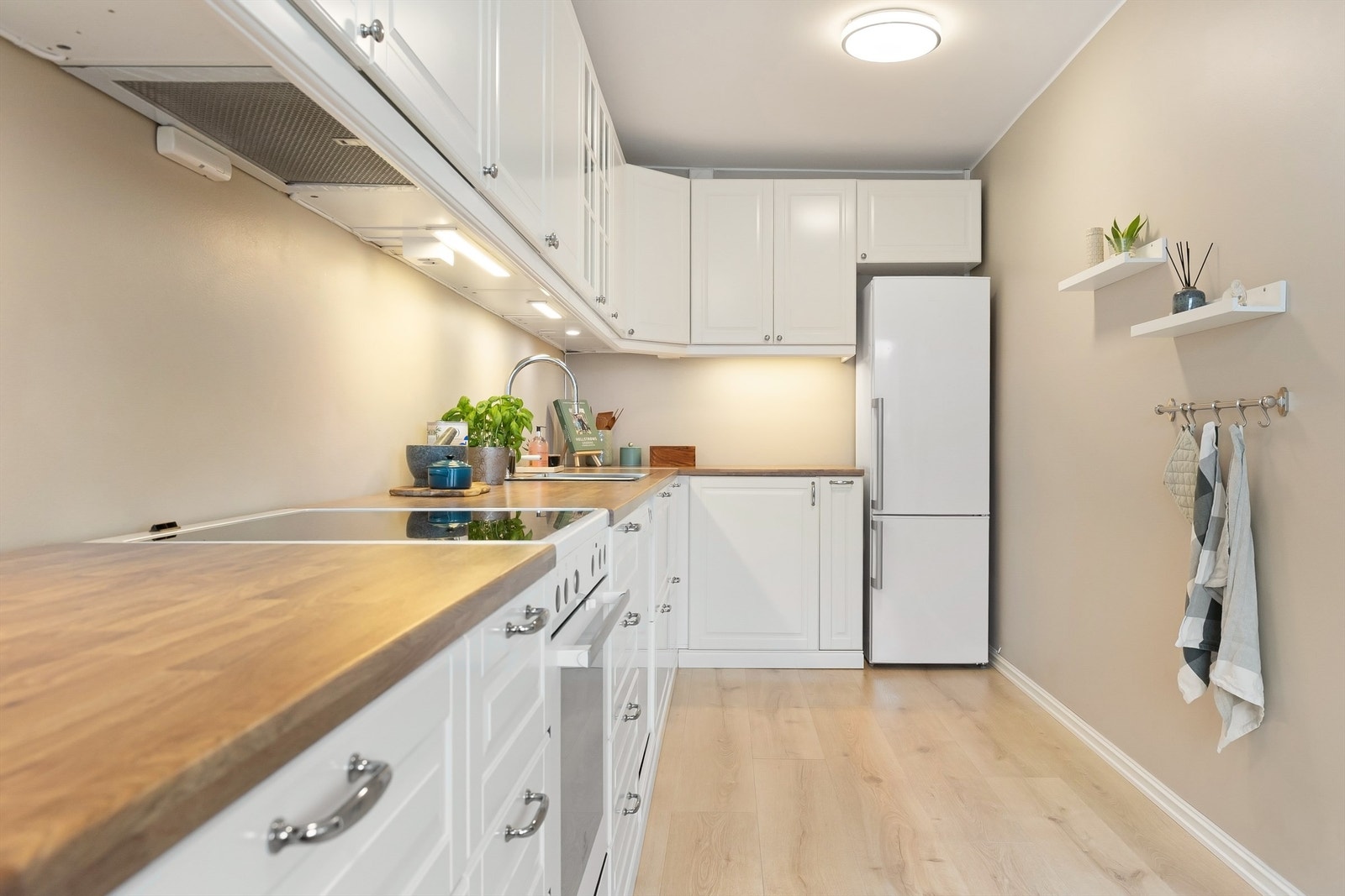 Innredningen har profilerte fronter på skap og skuffer, og benkeplater av laminat med nedfelt oppvaskkum Galleribilde